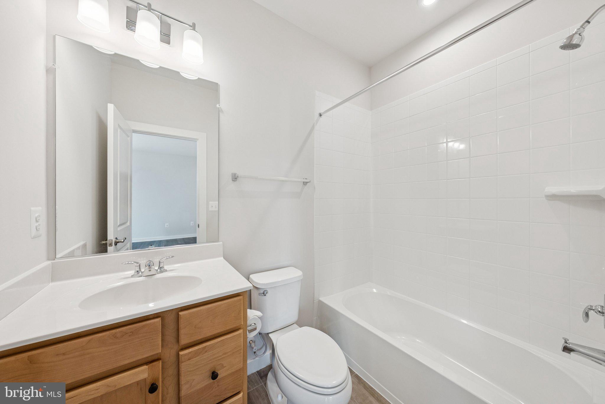 1655 Aspen Poplar Road Dumfries, VA 22026 - Photo 9 of 57 a bathroom with a sink a toilet and a bathtub
