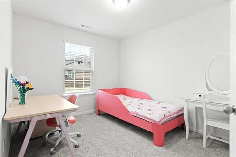 a bedroom with a bed and a table