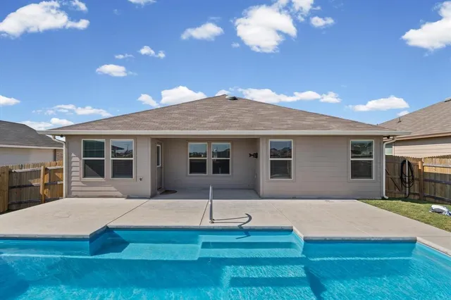 a view of a house with backyard porch and sitting area