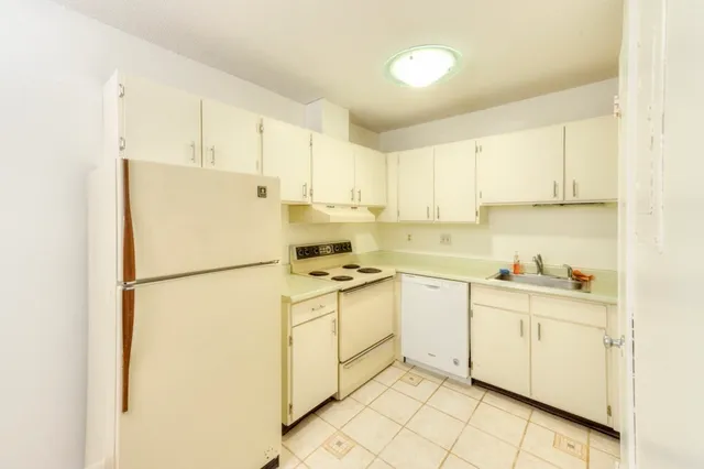 a kitchen with a white cabinets and white appliances