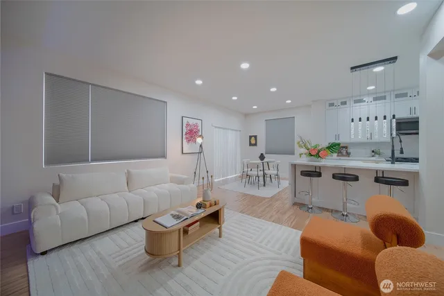 a living room with furniture and kitchen view