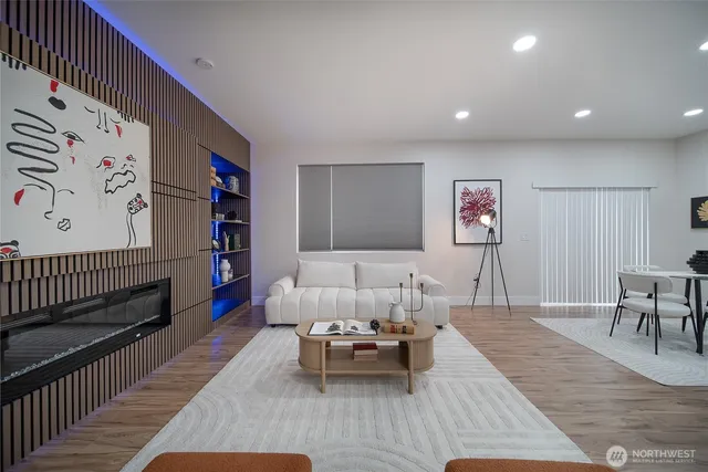 a living room with furniture and a wooden floor