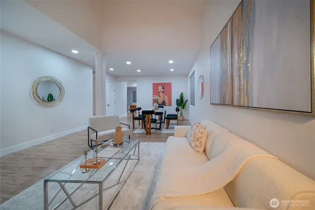 a living room with furniture and wooden floor
