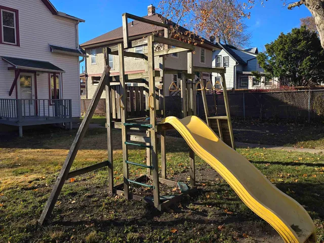 a view of a house with a wooden deck