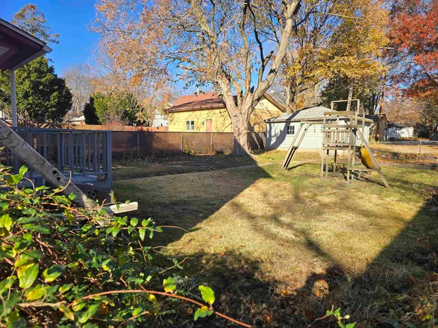 a view of yard with wooden fence
