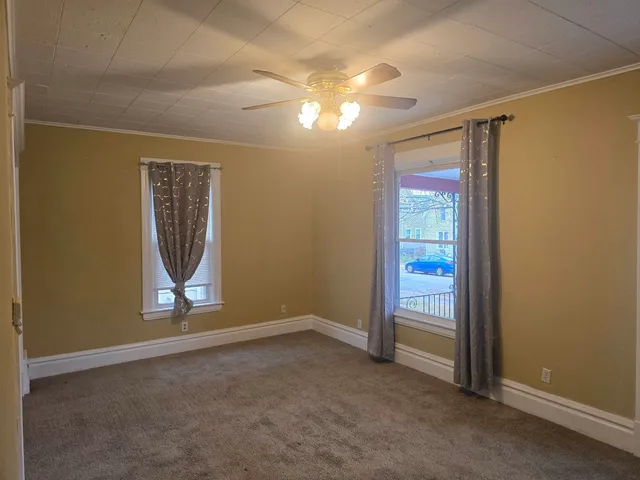an empty room with windows and closet