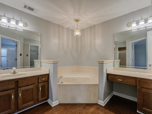 6387 St Elmo Road Bartlett, TN 38135 - Photo 14 of 30 The luxury primary bathroom features double vanities, whirlpool tub and walk-in shower.