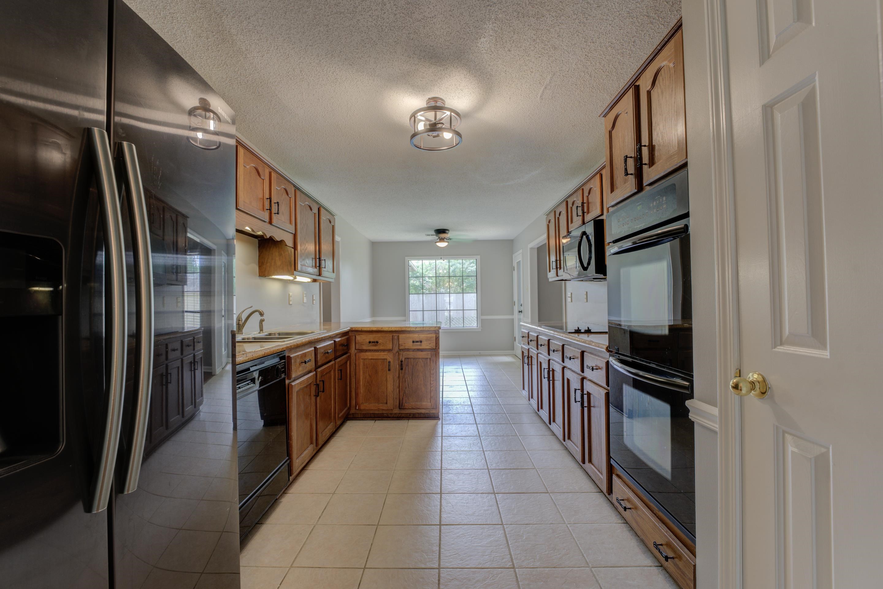 6387 St Elmo Road Bartlett, TN 38135 - Photo 8 of 30 Kitchen with light tile flooring, black appliances, ceiling fan, pantry and breakfast area.