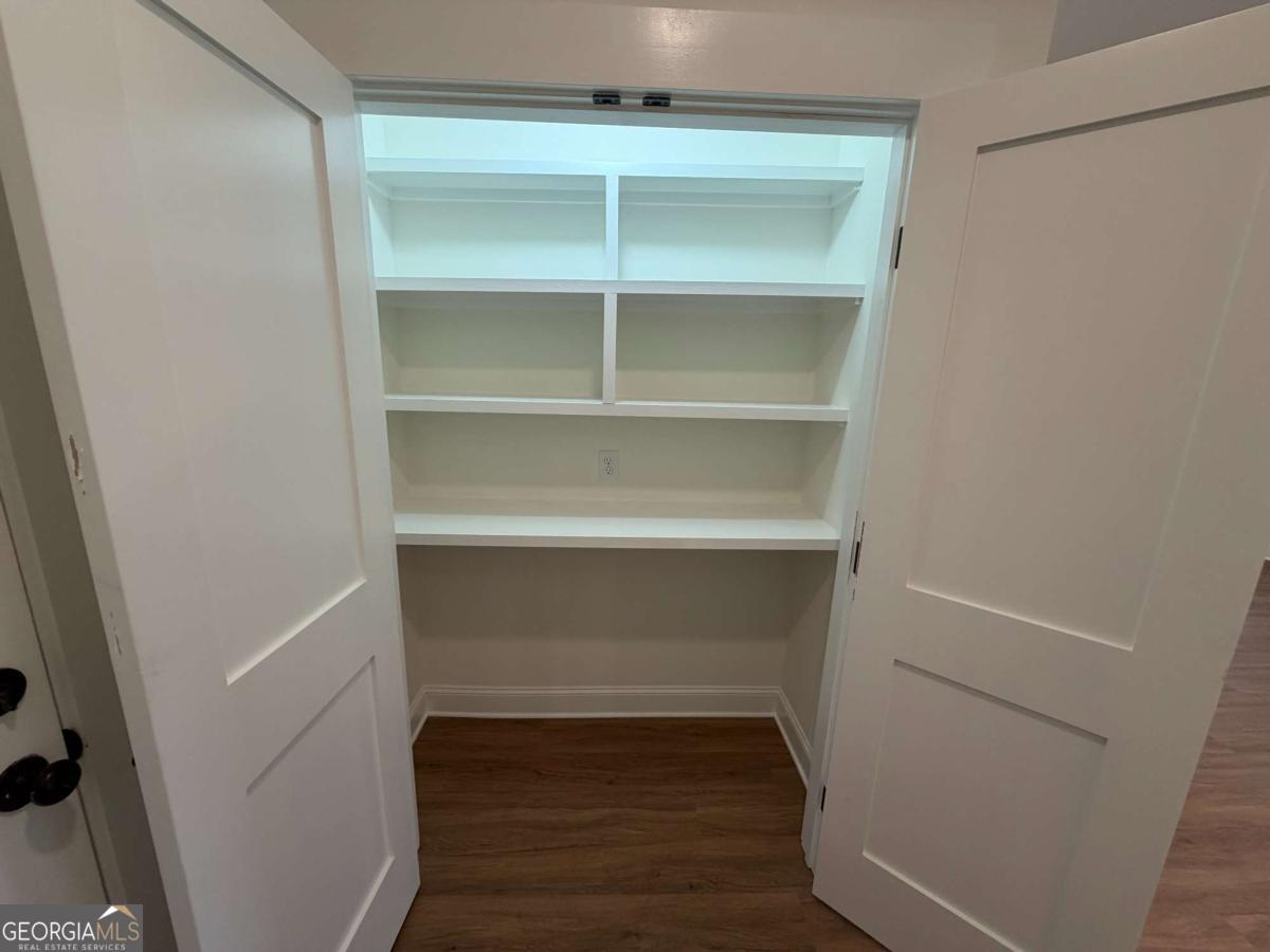350 Rucker Lane, Unit B Statesboro, GA 30458 - Photo 8 of 20 a view of walk in closet with empty racks