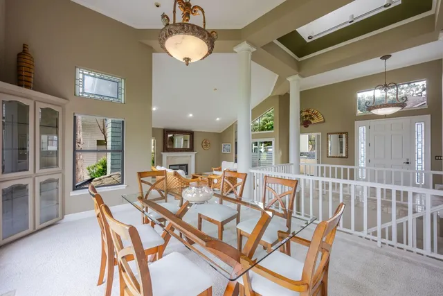 a view of a dining room with furniture a chandelier and wooden floor