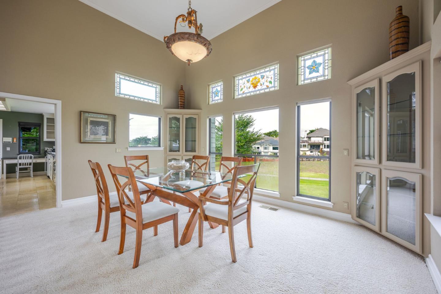 15 Ashdown Place Half Moon Bay, CA 94019 - Photo 12 of 53 a view of a dining room with furniture a chandelier and wooden floor