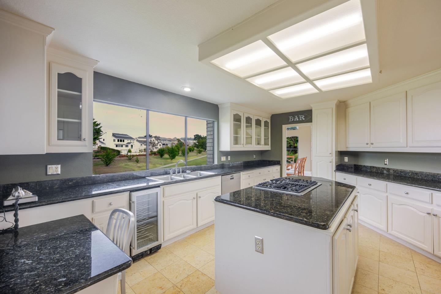 15 Ashdown Place Half Moon Bay, CA 94019 - Photo 13 of 53 a kitchen with granite countertop stainless steel appliances a sink stove and cabinets
