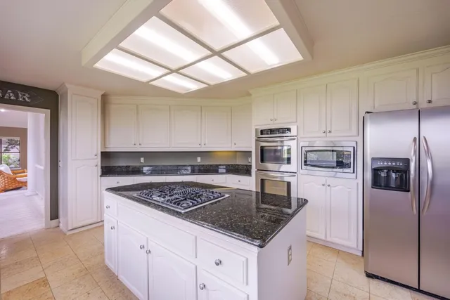 a dining room with furniture a chandelier and wooden floor