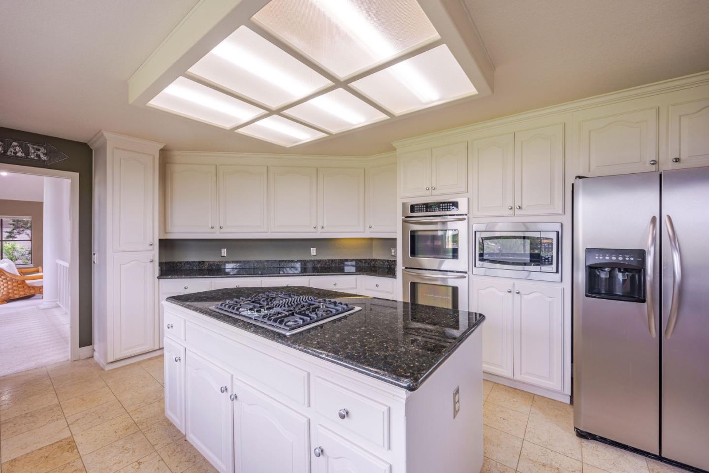 15 Ashdown Place Half Moon Bay, CA 94019 - Photo 14 of 53 a kitchen with stainless steel appliances granite countertop a refrigerator and a stove top oven