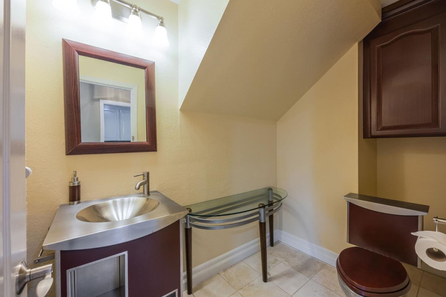15 Ashdown Place Half Moon Bay, CA 94019 - Photo 16 of 53 a bathroom with a toilet a sink and mirror