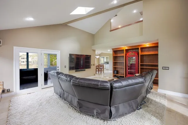 a living room with a rug and a fireplace