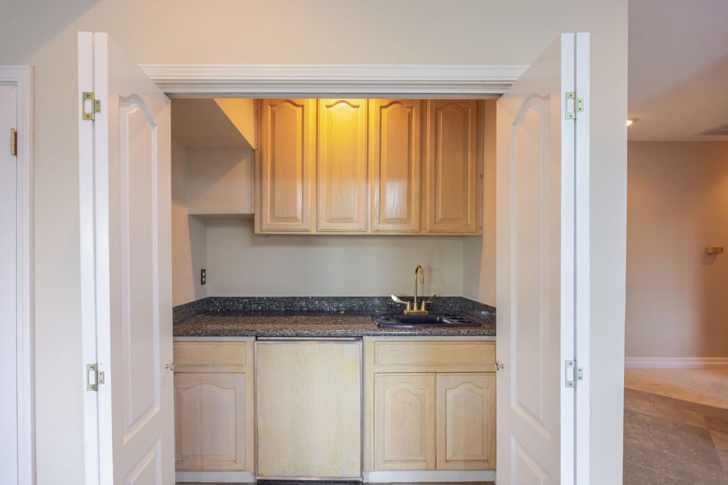 15 Ashdown Place Half Moon Bay, CA 94019 - Photo 23 of 53 a kitchen with granite countertop white cabinets and stainless steel appliances
