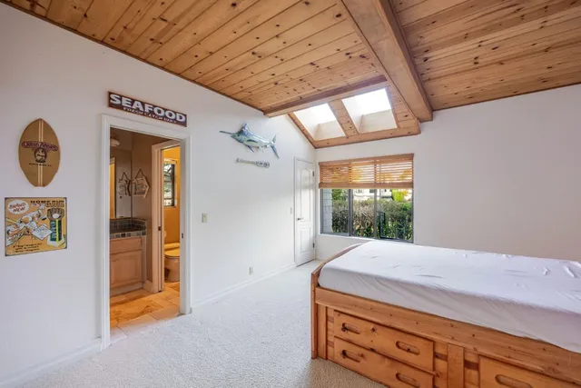 a bathroom with a granite countertop sink a toilet a mirror and shower