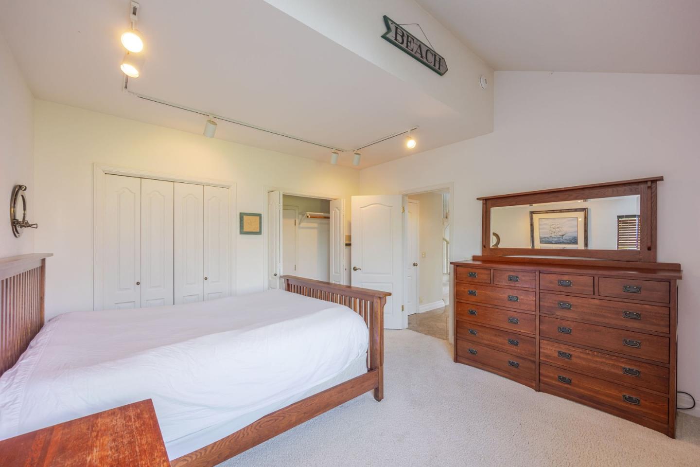 15 Ashdown Place Half Moon Bay, CA 94019 - Photo 30 of 53 a spacious bedroom with a bed and a dresser