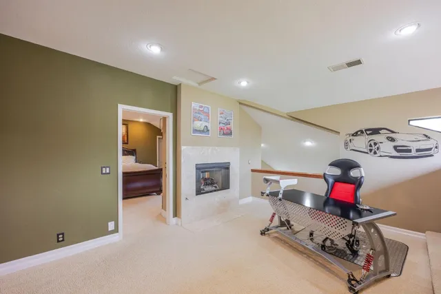a spacious bedroom with a large bed and a chandelier