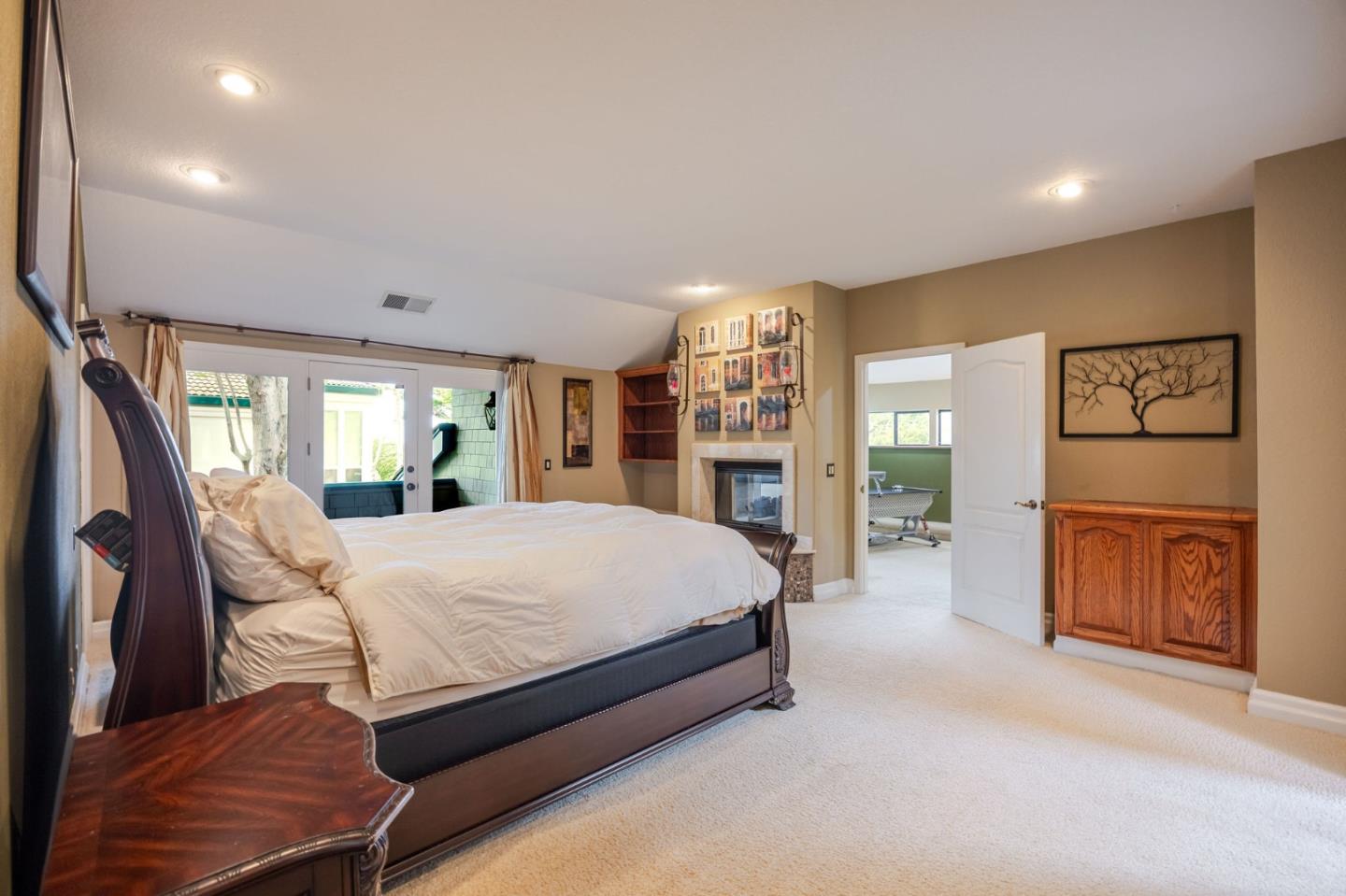 15 Ashdown Place Half Moon Bay, CA 94019 - Photo 34 of 53 a spacious bedroom with a large bed and a chandelier