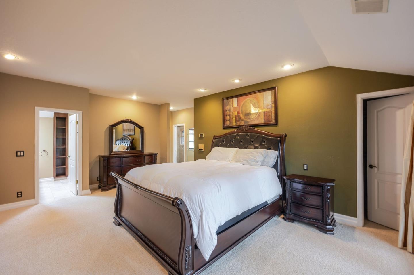 15 Ashdown Place Half Moon Bay, CA 94019 - Photo 35 of 53 a spacious bedroom with a bed and a flat screen tv