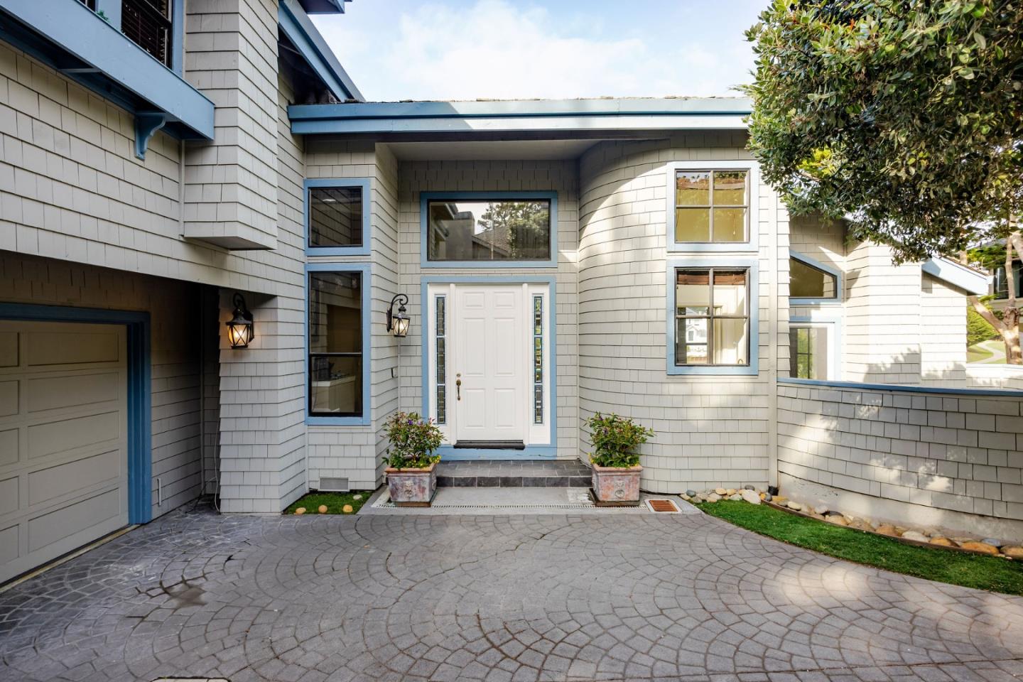 15 Ashdown Place Half Moon Bay, CA 94019 - Photo 4 of 53 a front view of a house with a yard and garage