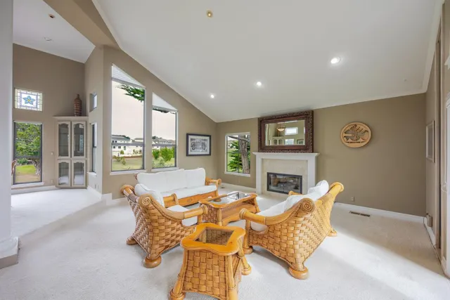 a living room with furniture large window and fireplace