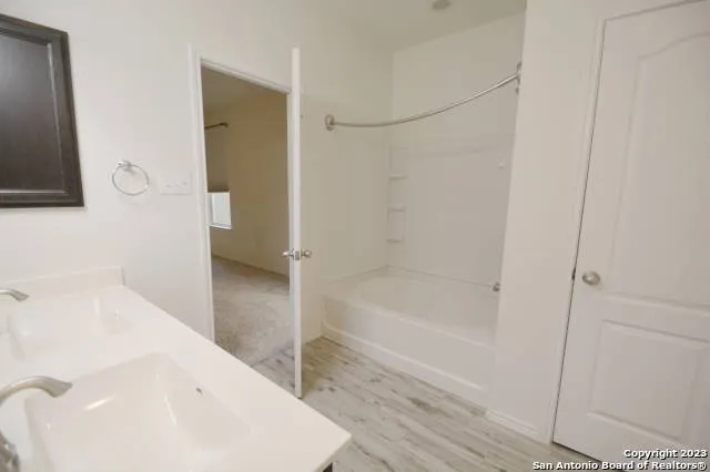 a bathroom with a bathtub and a sink