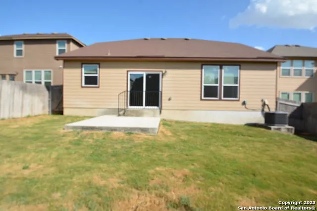a view of a roof deck with wooden fence and plants