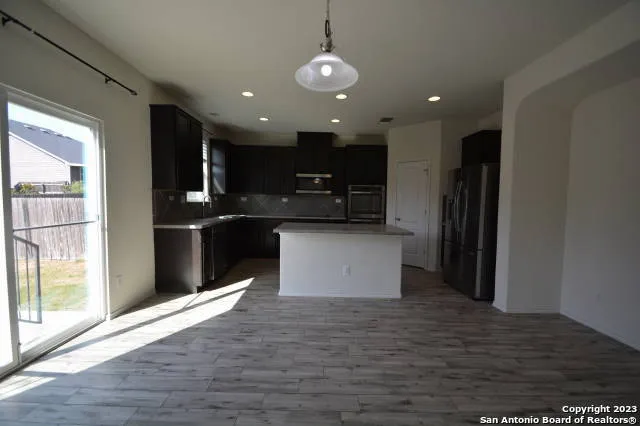 a kitchen with stainless steel appliances granite countertop a refrigerator and a sink