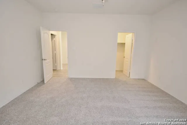 a view of an empty room and closet area