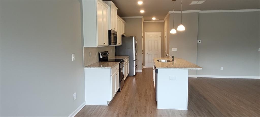 5141 Fox Den Road Oakwood, GA 30566 - Photo 11 of 29 a kitchen with a sink and refrigerator