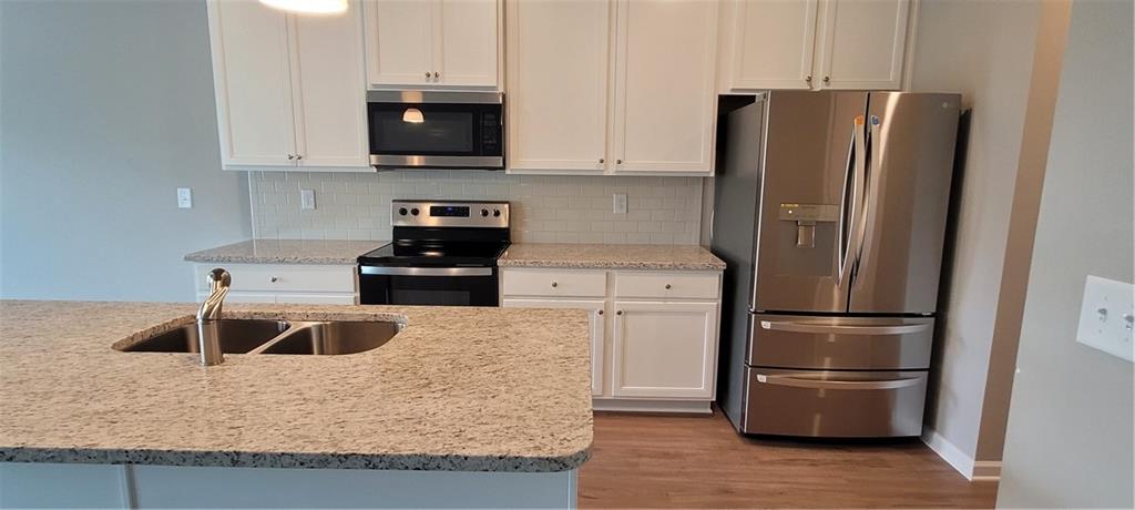 5141 Fox Den Road Oakwood, GA 30566 - Photo 13 of 29 a kitchen with a refrigerator sink and microwave