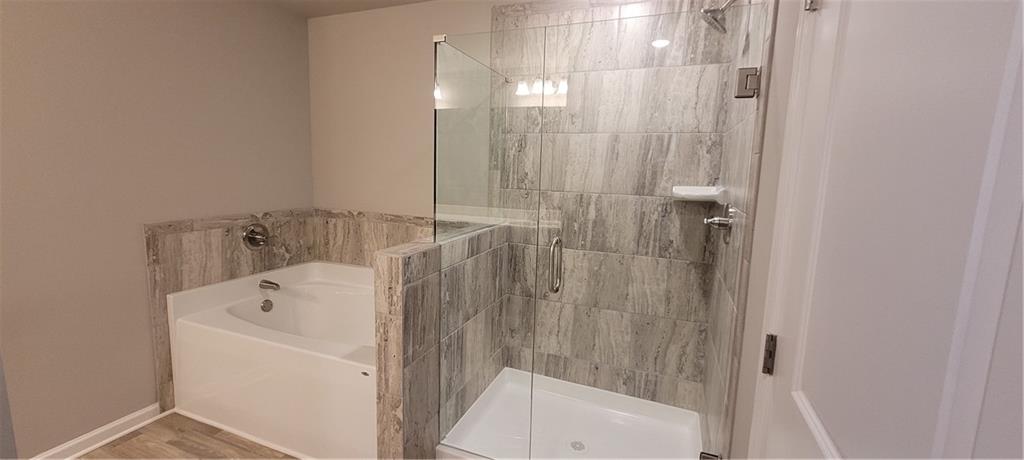 5141 Fox Den Road Oakwood, GA 30566 - Photo 21 of 29 a bathroom with a bathtub and shower