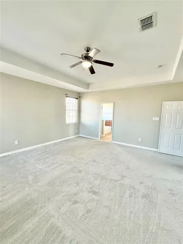 a view of empty room with ceiling fan