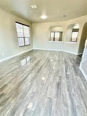a view of an empty room and wooden floor