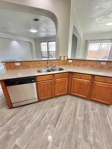 a view of a large kitchen with sink and microwave