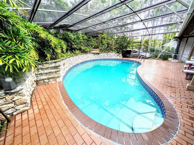a view of a swimming pool with a patio