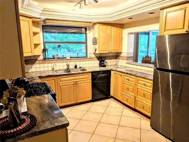 a kitchen with a stove a sink and a refrigerator