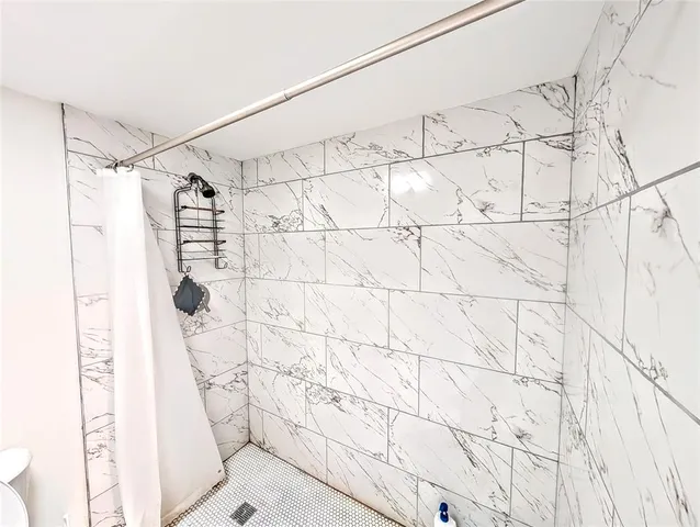 a bedroom with a bed window and flat screen tv