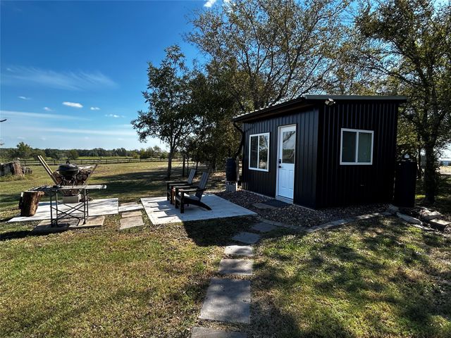 a view of kitchen with microwave and refrigerator