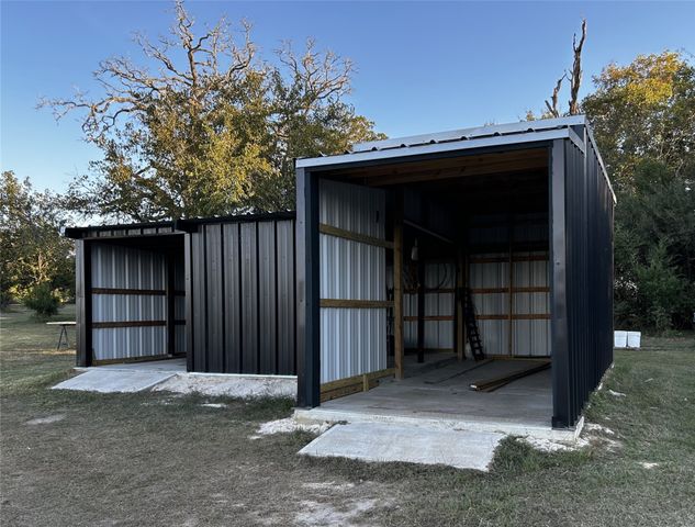 a view of a backyard with wooden fence