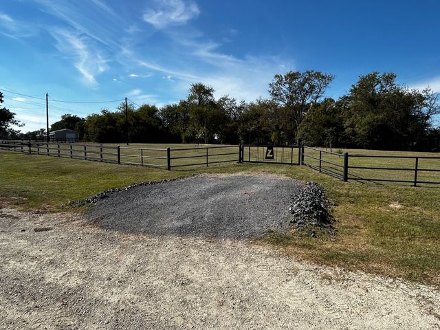 a view of outdoor space with green field and trees