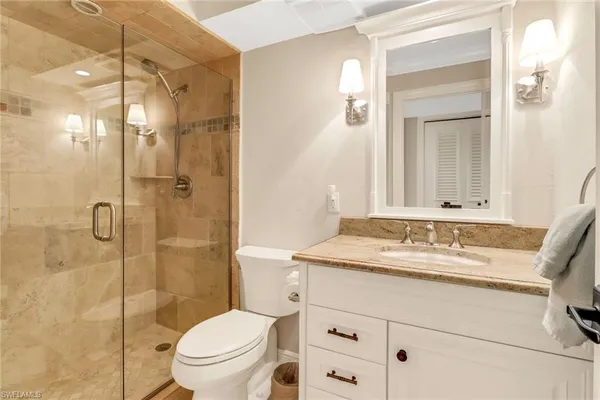 a bathroom with a shower a toilet and a sink