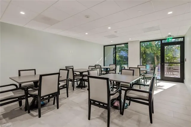 a kitchen with granite countertop a refrigerator a microwave a stove and a center island