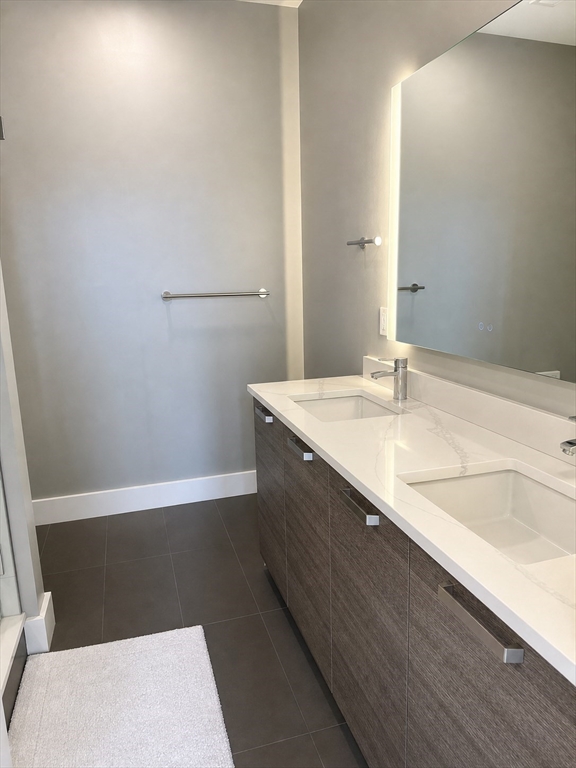 30 Penniman Road, Unit 501 Boston, MA 02134 - Photo 11 of 20 a bathroom with a sink a toilet and tub