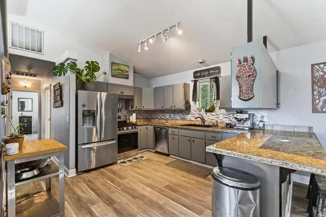 a kitchen with a sink stove and cabinets