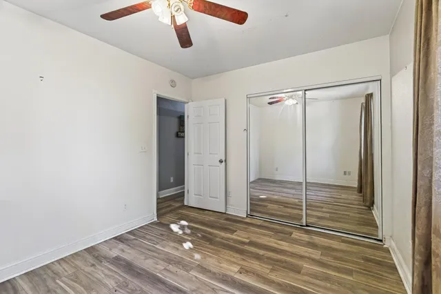 a bathroom with a granite countertop toilet sink and mirror
