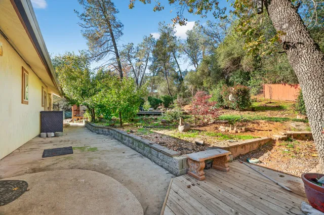 a backyard of a house with table and chairs